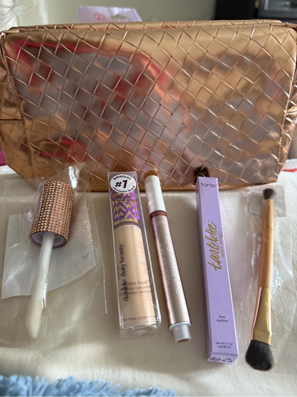 TARTE  bag with concealer, lip oil, eyeliner, shadow double ended brush